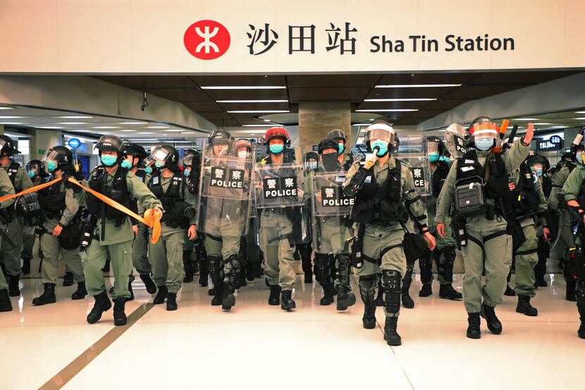Riot police enter a shopping mall on May 1 to disperse pro-democracy protesters during Labor...
