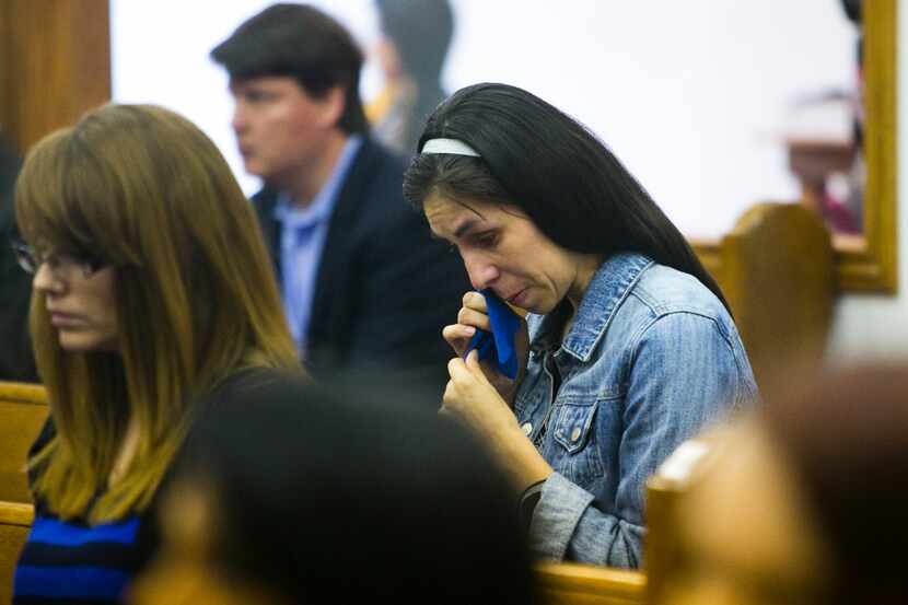 Kathy Abad, a military wife, mourns during a memorial church service for those killed and...