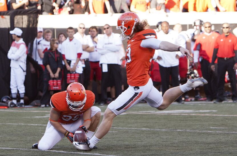 Nov 17, 2012; Stillwater OK, USA; Oklahoma State Cowboys holder Wes Harlan (39) holds the...