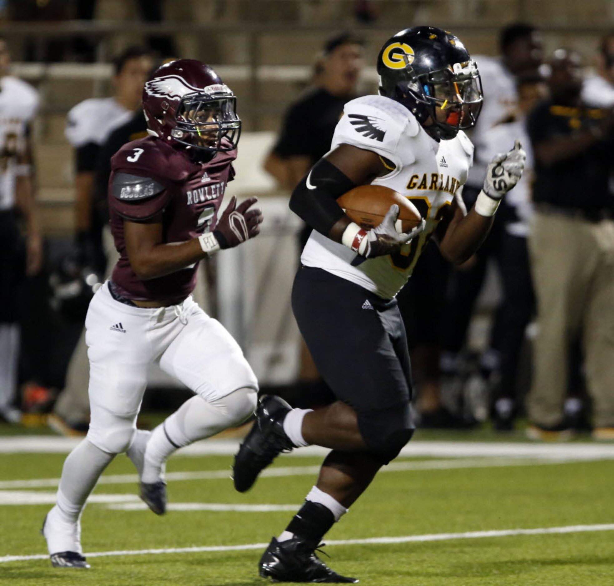 (TXHSFB) Garland's Michael Turman (32) breaks loose for a long gain, as Rowlett defender...