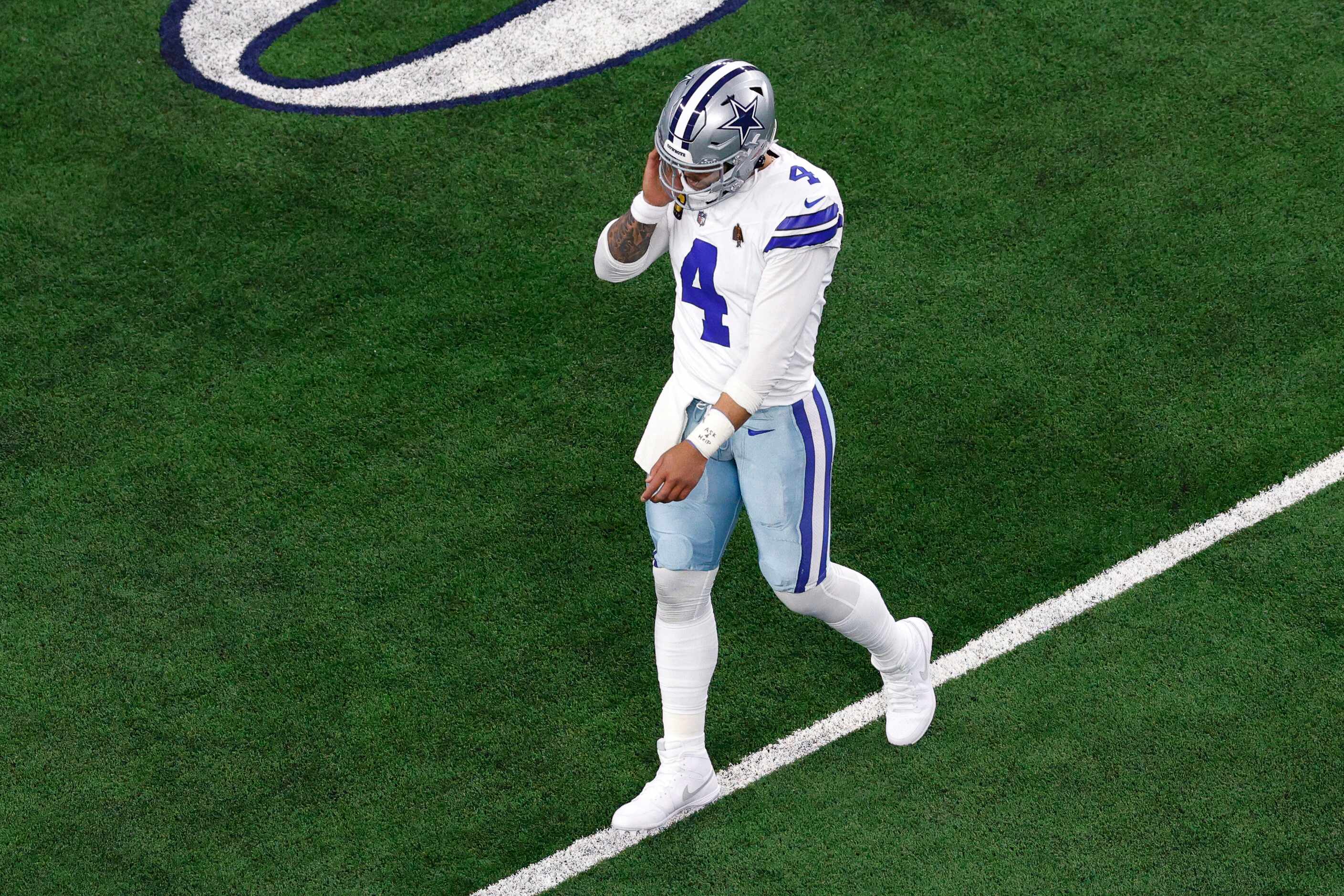 Dallas Cowboys quarterback Dak Prescott (4) walks off the field after throwing an...