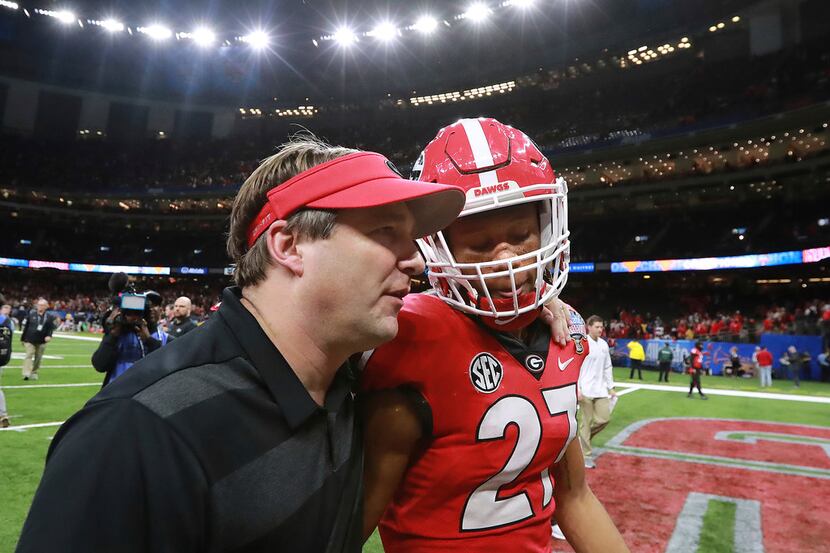 Georgia coach Kirby Smart consoles defensive back Eric Stokes after the team's 28-21 loss to...