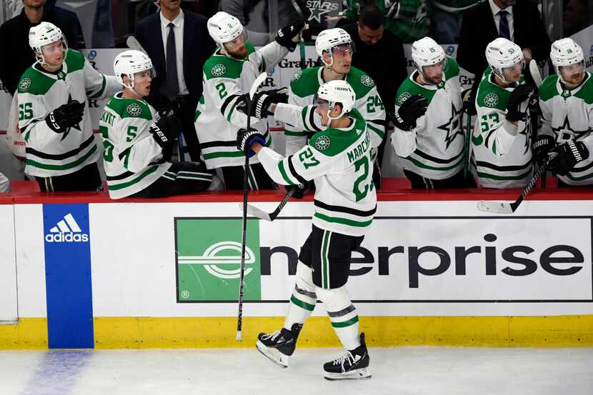 Dallas Stars' Mason Marchment (27) celebrates with teammates at the bench after scoring...