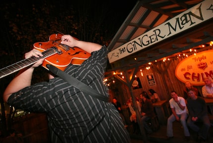 In this 2008 file photo, Robbie Clements plays his guitar behind his head in the backyard of...