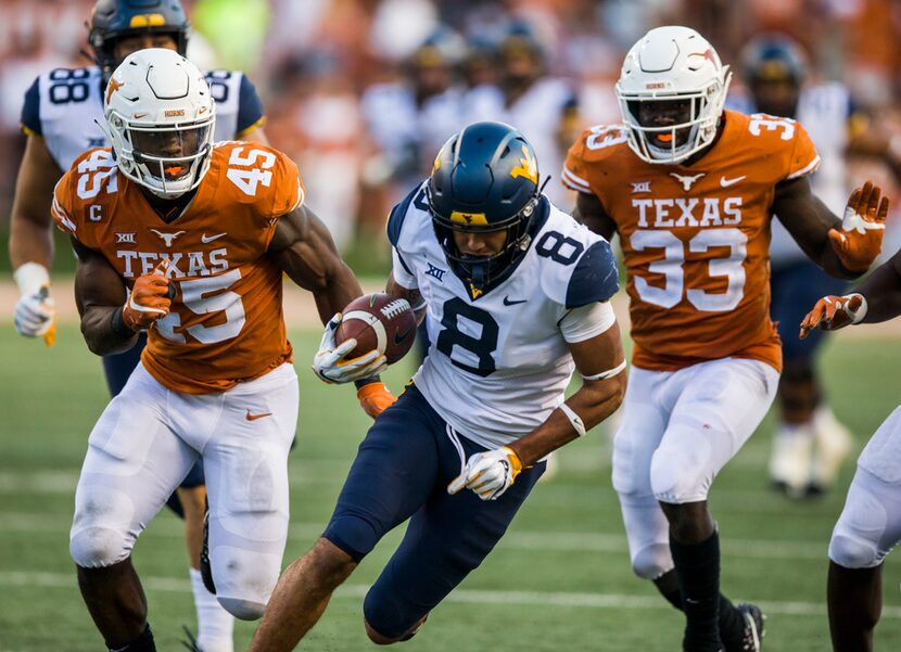 Texas Longhorns linebacker Anthony Wheeler (45) and linebacker Gary Johnson (33) run after...