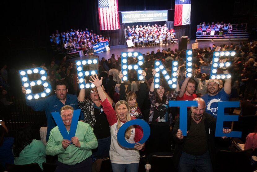  Supporters of Sen. Bernie Sanders try to excite the crowd during his campaign stop at the...