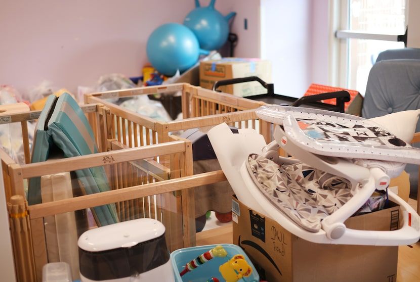 Furniture and toys have been stacked and wrapped in one of the water damaged rooms as the...