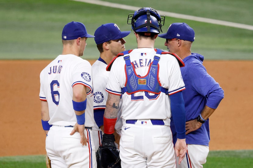 Texas Rangers pitcher Jack Leiter (35) , second from left, talks with Texas Rangers pitching...