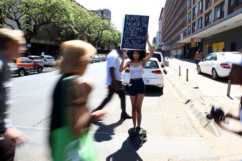 Teen activist Zulaikha Patel and member of the Black Radical Feminists holds a placard...