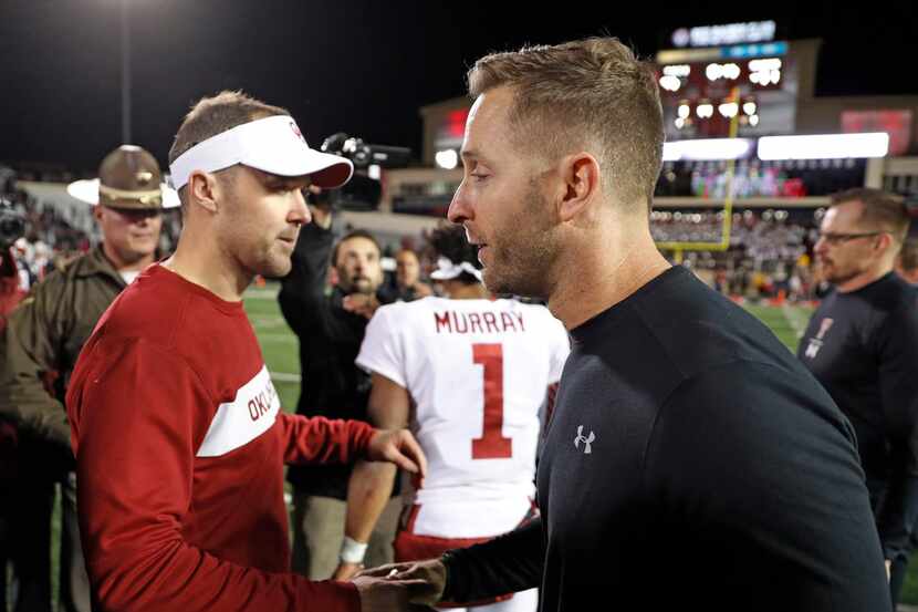 Oklahoma coach Lincoln Riley, left, shakes hands with Texas Tech coach Kliff Kingsbury after...