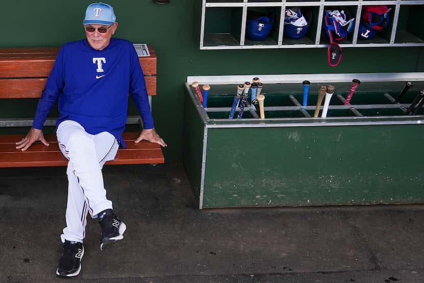 Texas Rangers manager Bruce Bochy looks out from the dugout before a spring training game...