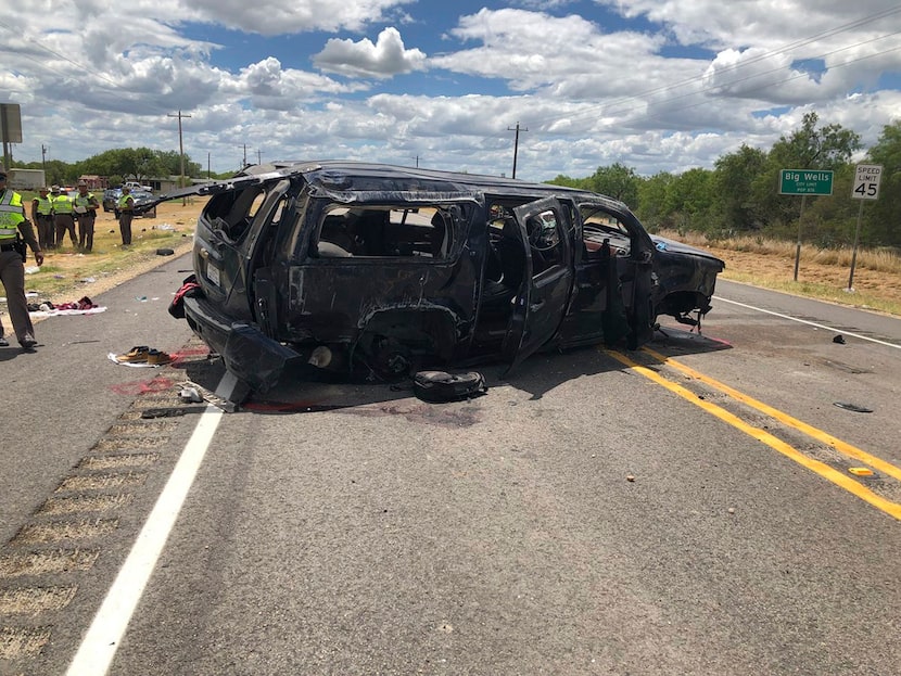 A heavily damaged SUV is seen on Texas Highway 85 in Big Wells, Texas, after crashing while...