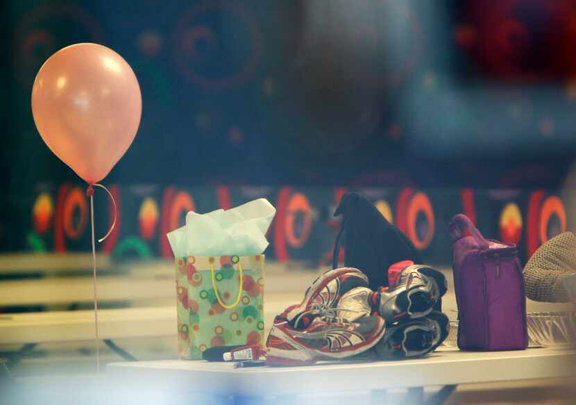 Birthday presents and personal belongings of partygoers remain in the rink following a...
