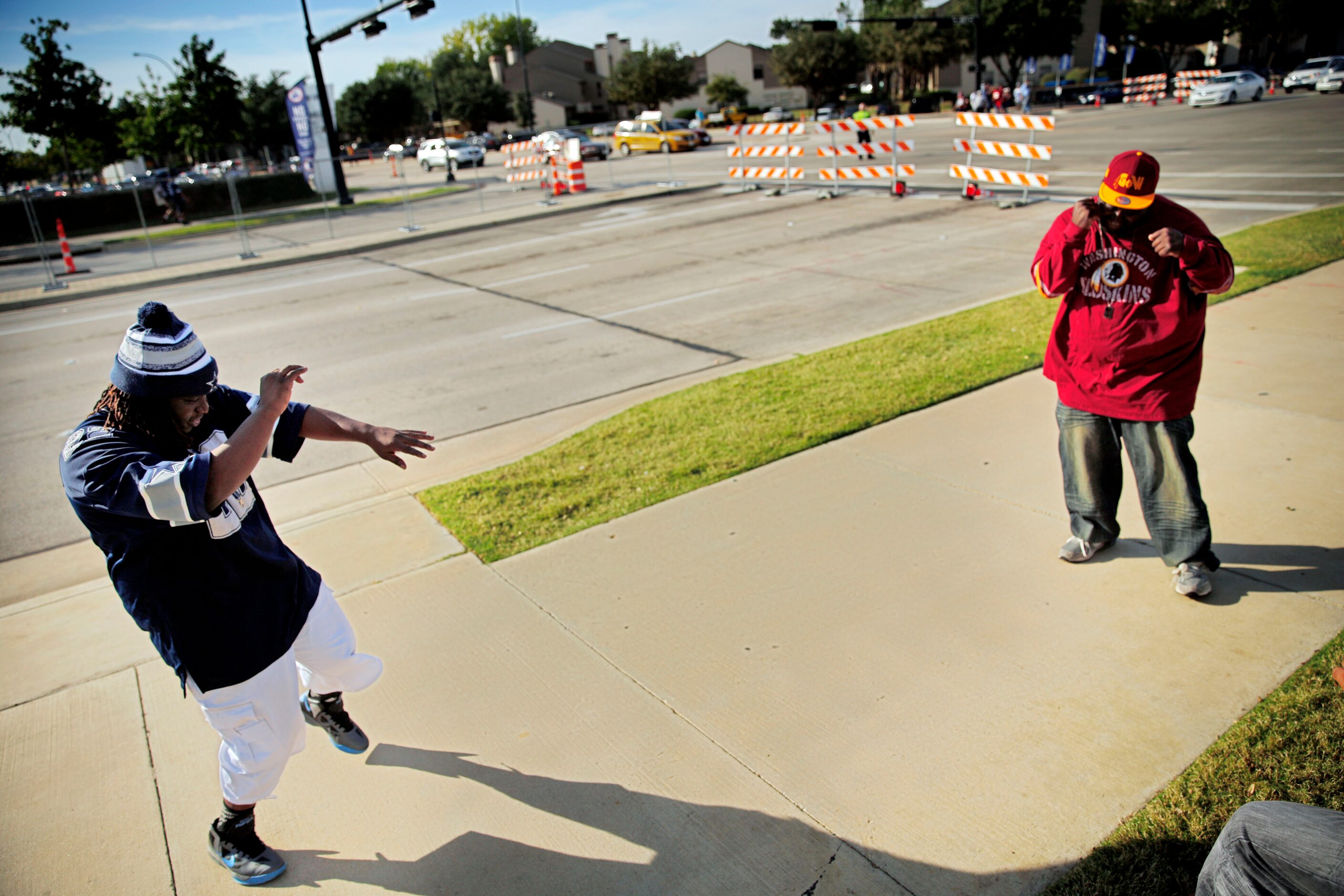 Clevon Tilghman (left) and Lawrence Baldwin dance before the Dallas Cowboys game against the...