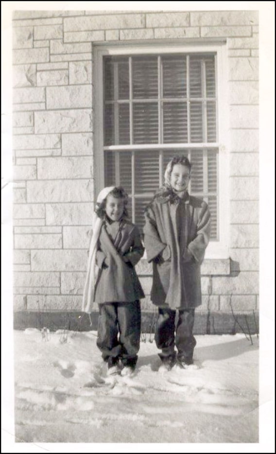 Sisters Ann "Auntie" Sanford (right) and Sara Munroe pose for a photograph in front of the...