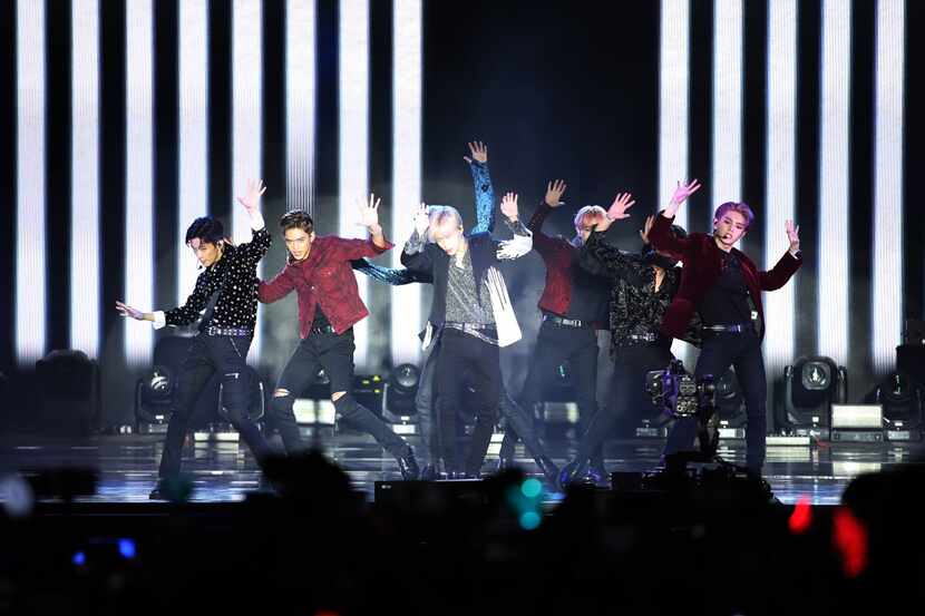 Members of the Korean pop supergroup SuperM perform in Los Angeles in 2019. Fans of K-pop...