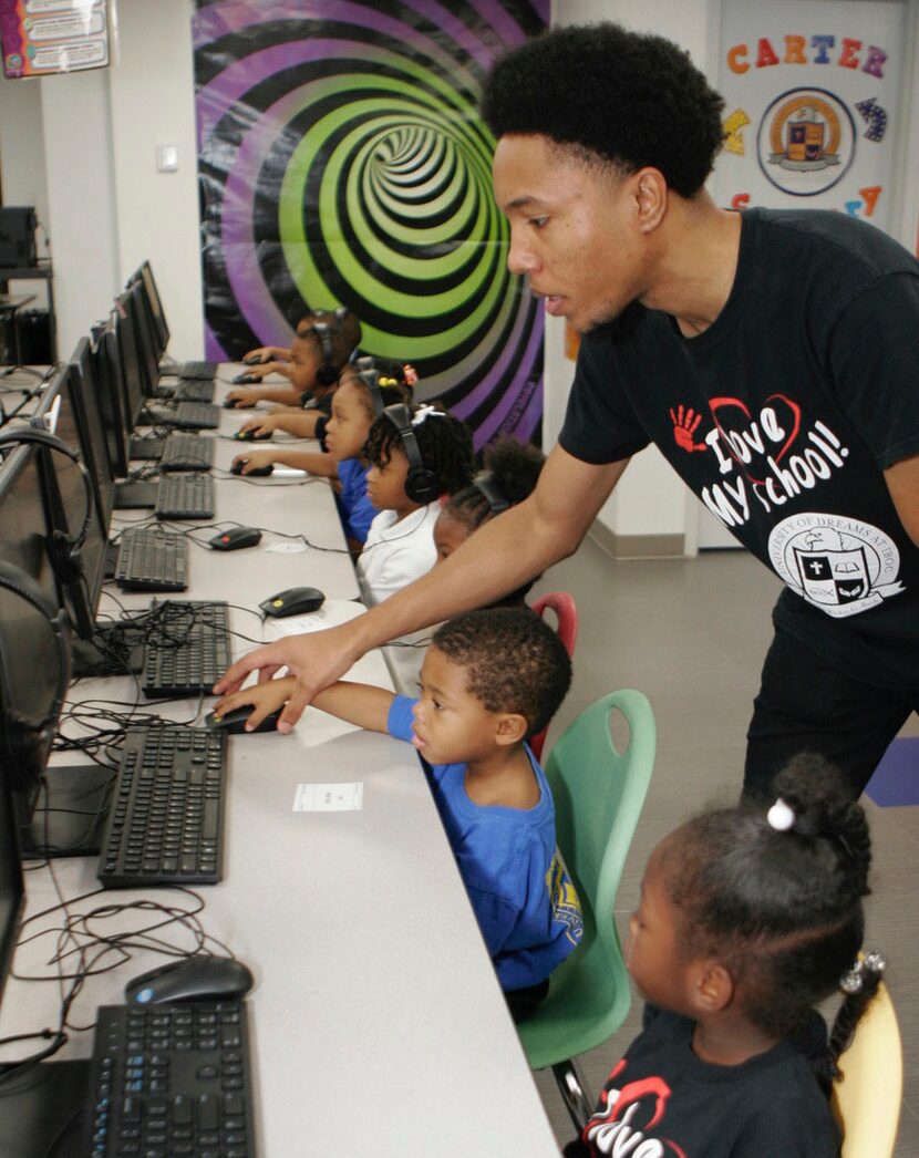 Technology instructor Andrew Carter worked with students last fall in the computer lab at...