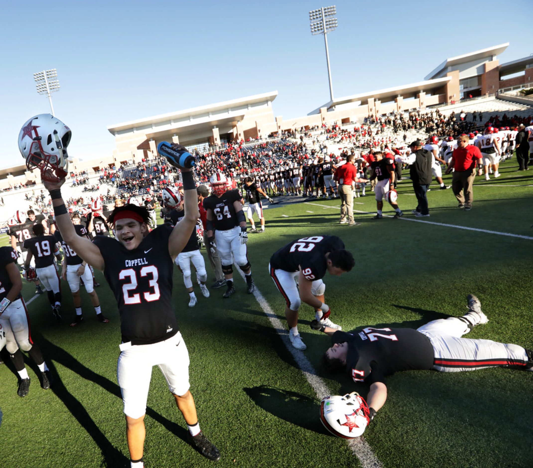 Coppell players Colin Arteaga (23) and Luke Dvorak (77) and Joseph Sheddy celebrate after a...