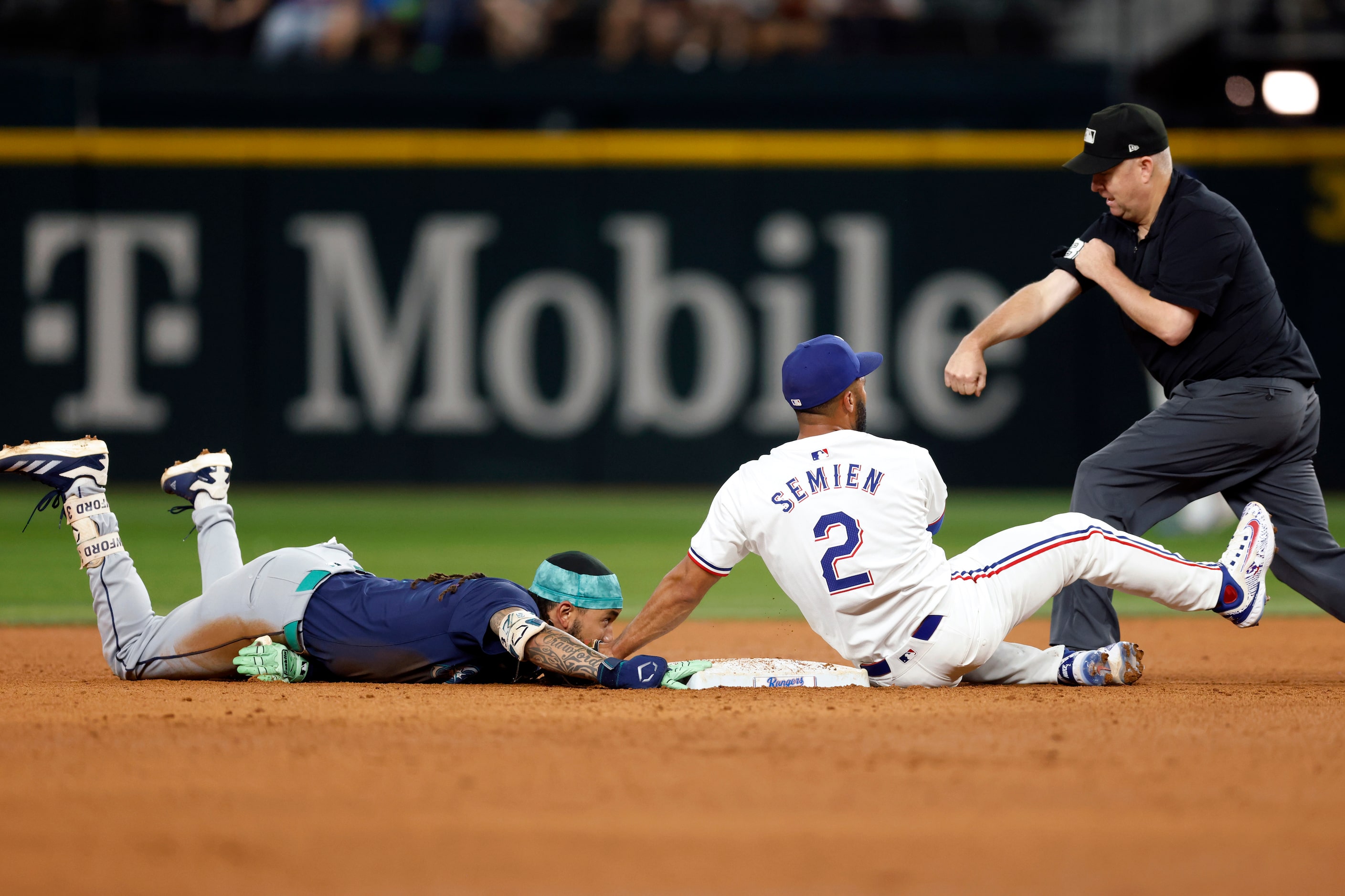 Umpire Todd Tichenor (13) calls out Seattle Mariners shortstop J.P. Crawford (3) after he...