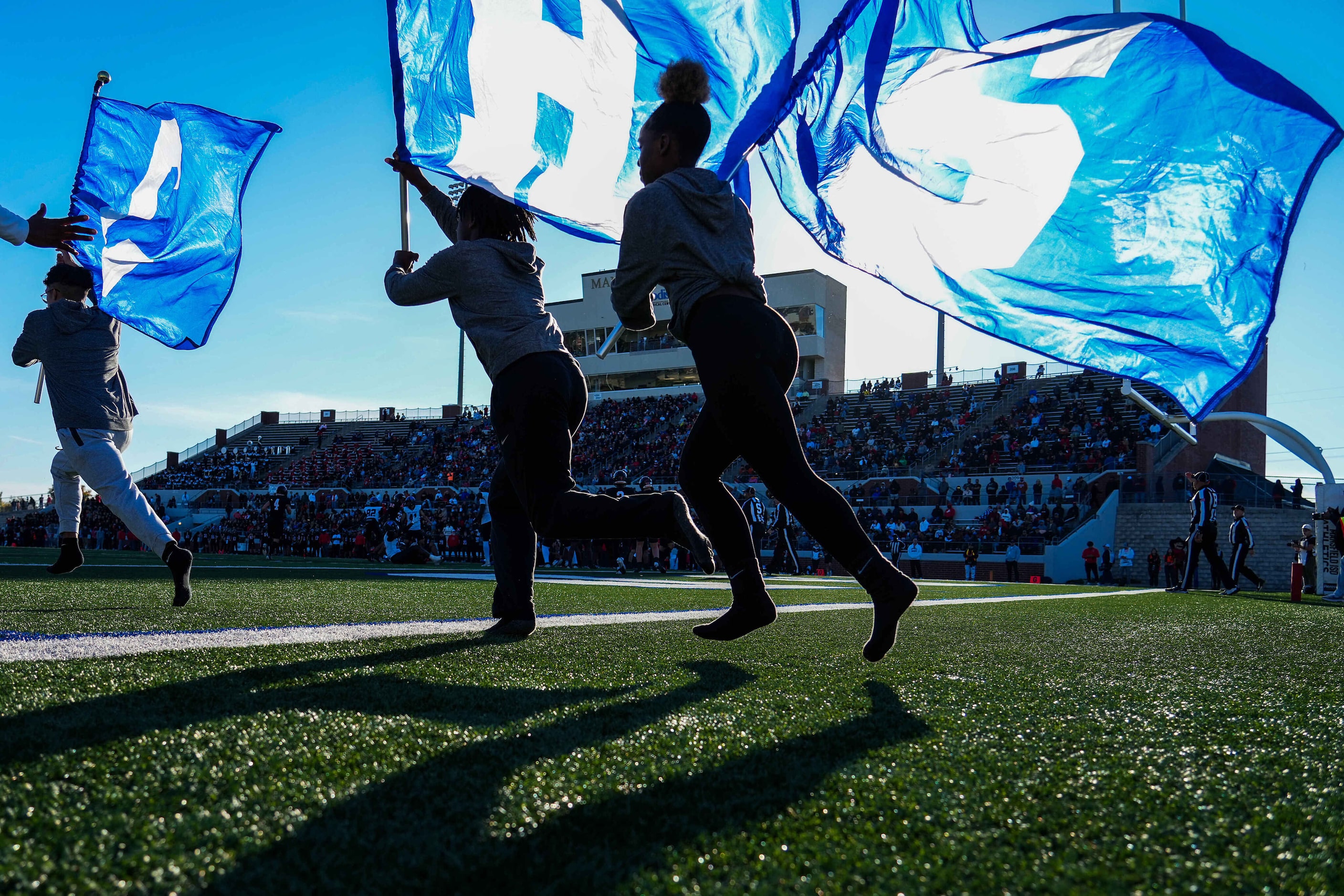 North Crowley flag runners take the field after a touchdown during the second half of a UIL...