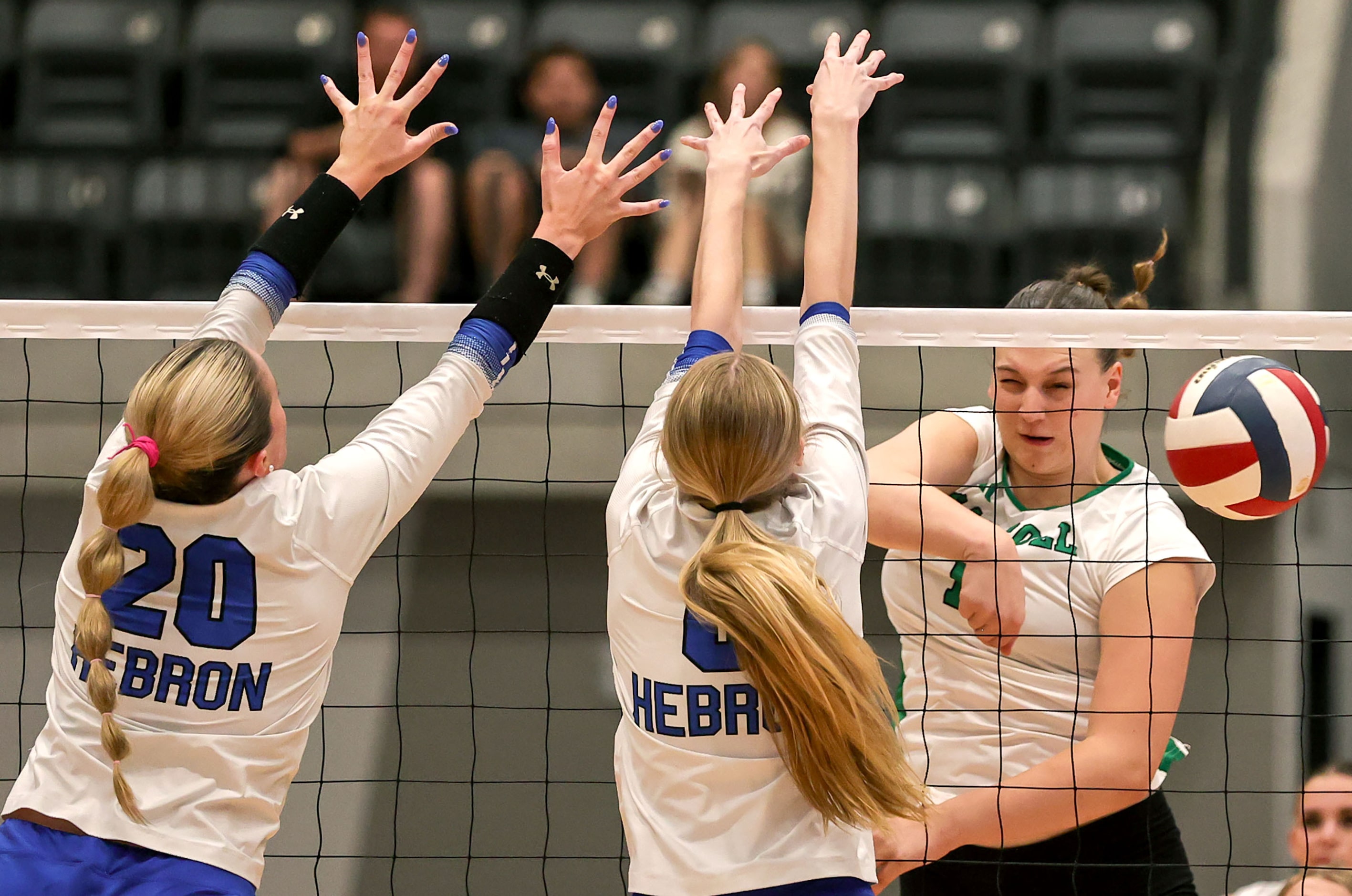 Southlake Carroll's Kinsley Young (R) gets a kill past Hebron's Marley Rogers (6) and...