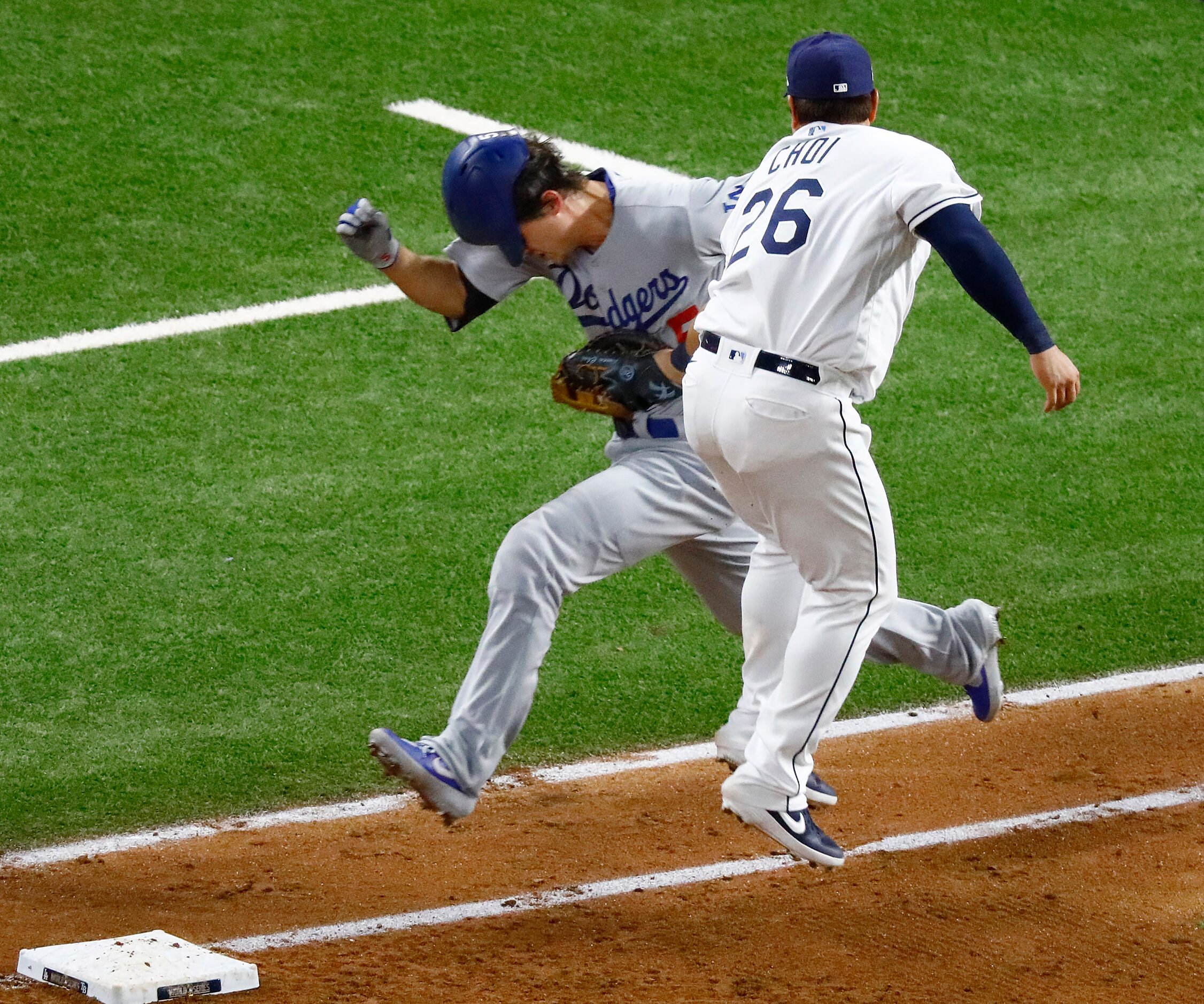 Tampa Bay Rays first baseman Ji-Man Choi (26) leaps to catch a throw and tag out Los Angeles...