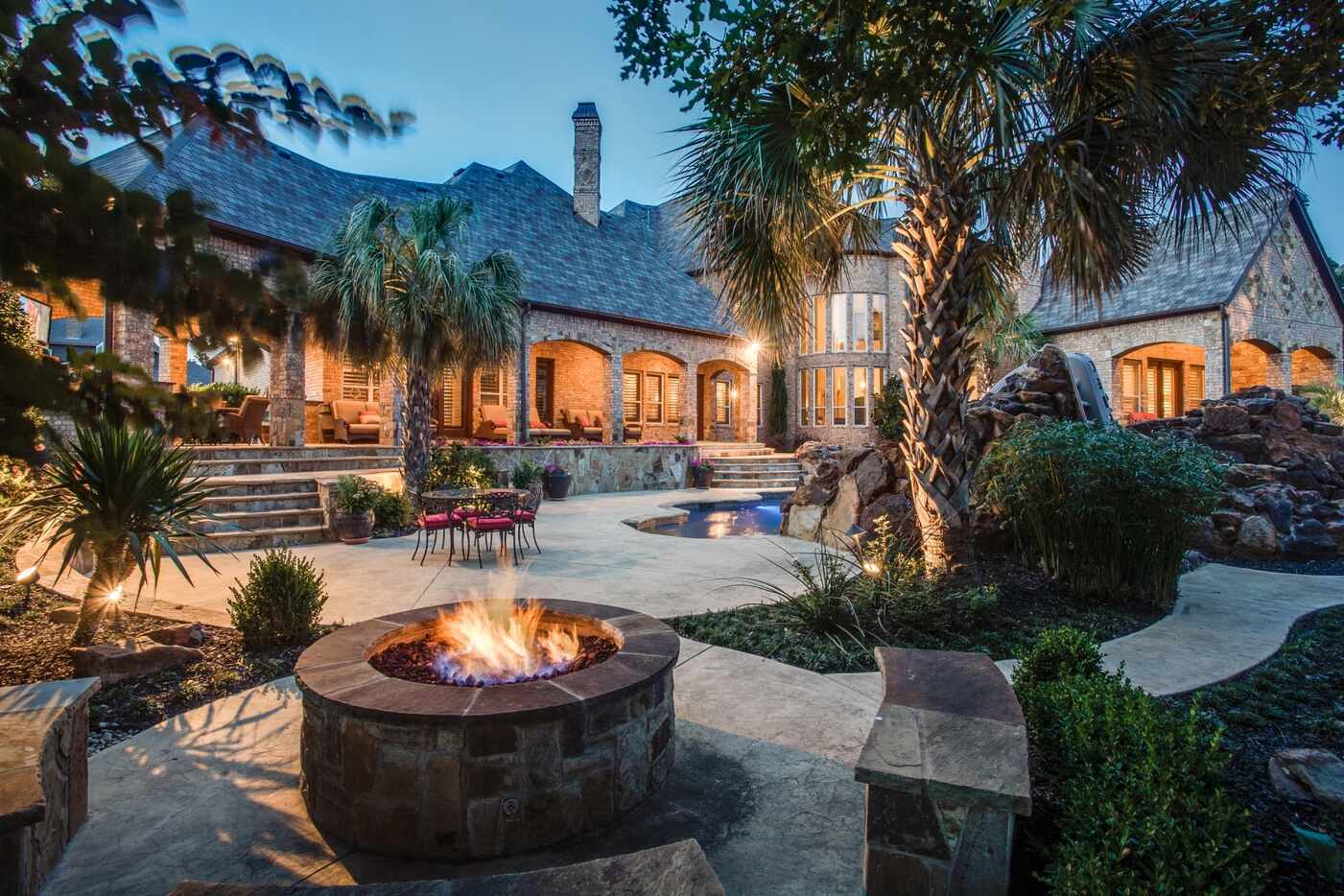 The home has a large outdoor entertaining area, including a fire pit.