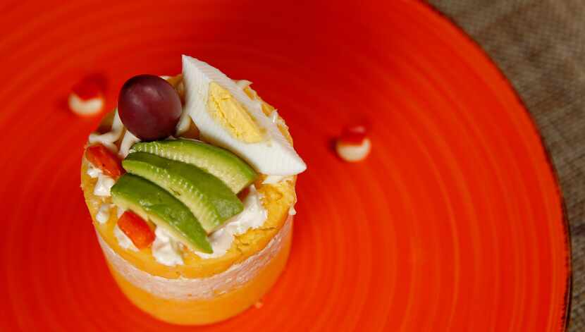 Causa limeña is a delicious terrine of whipped potato layered with shredded chicken and...