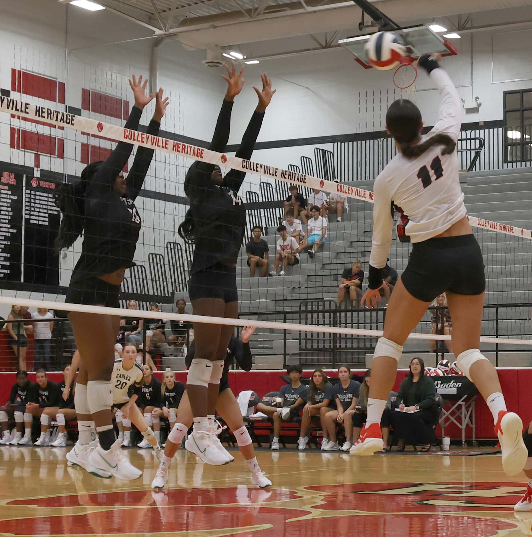 Colleyville Heritage outside hitter Suli Davis (11), right, fires a shot around two proper...