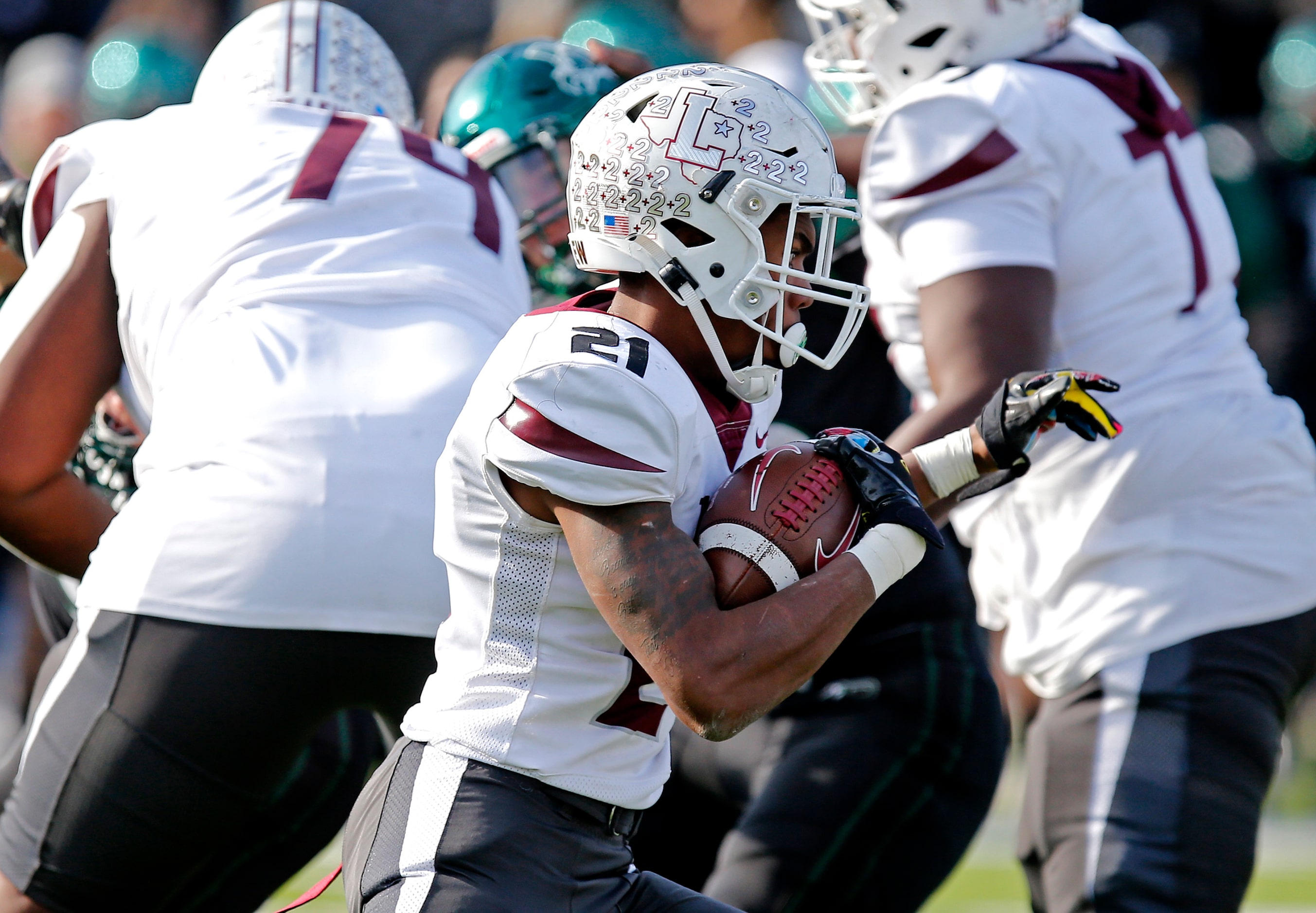 Lewisville High School running back Viron Ellison (21) carries the ball during the first...