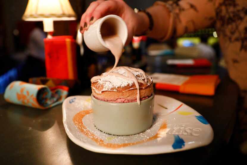 Staff drizzles a Raspberry Souffle dessert with a raspberry creme anglaise at Rise No. 3 in...