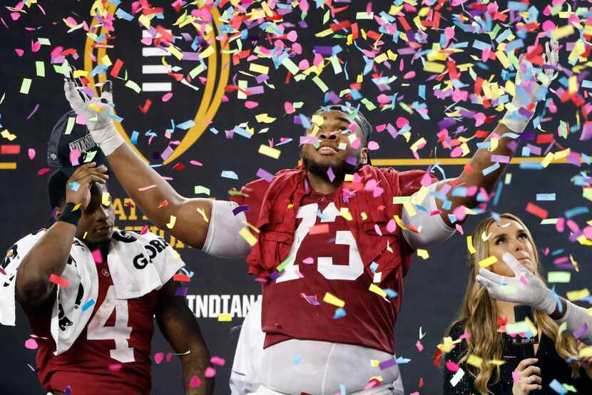 Alabama offensive lineman Evan Neal (73) tosses confetti after the Cotton Bowl NCAA College...