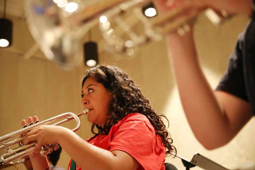 Camper Valeria Ibarra, 17, of Krum, Texas, practices the trumpet during an exercise session...