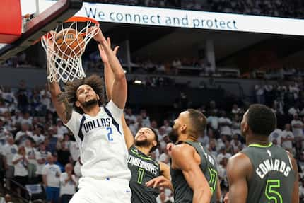 Dallas Mavericks center Dereck Lively II (2) dunks past Minnesota Timberwolves forward Kyle...