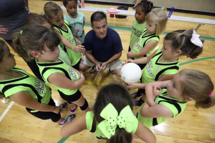 Coach Mitch Metersky gave Lil' Smash players a pep talk before the volleyball team's game...