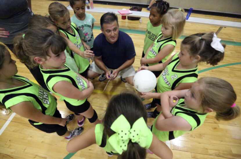 Coach Mitch Metersky gave Lil' Smash players a pep talk before the volleyball team's game...