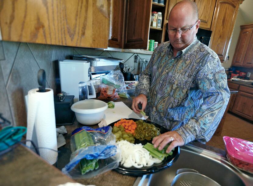 Ricky Kleibrink prepares a relish dish at his home in Decatur. He was on the verge of being...