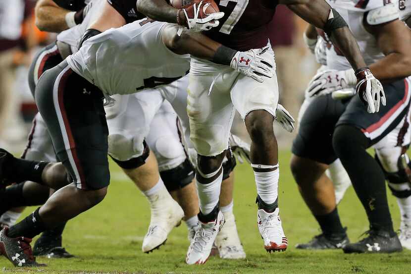 COLLEGE STATION, TX - SEPTEMBER 30:  Keith Ford #7 of the Texas A&M Aggies rushes past...
