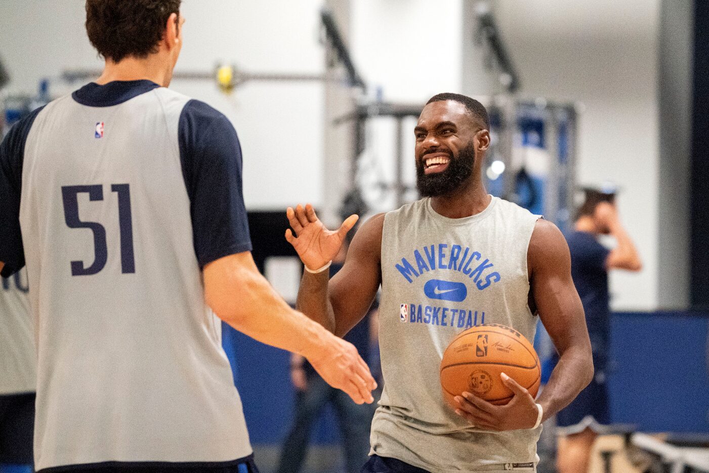 Dallas Mavericks guard Tim Hardaway Jr. laughs with center Boban Marjanović during a...