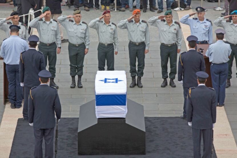 Israeli generals salute in front of the coffin of ex-Prime Minister Ariel Sharon at the...