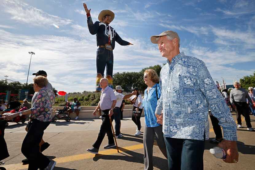 Vietnam veteran Jack Dwyer, 82, of Hawaii and his wife, Barbara Dwyer, 83, walk by Big Tex...