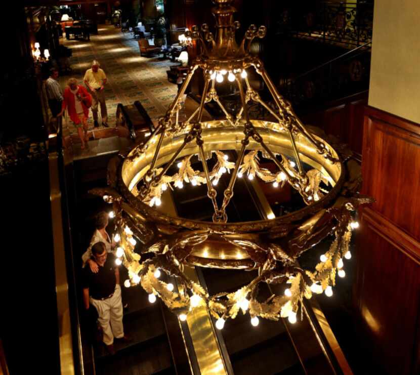 An original chandelier hangs above the escalator near the registration desk.