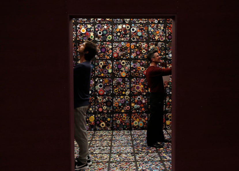 The artists William Ladd (left) and Steven Ladd (right) stand inside their work "Scroll...