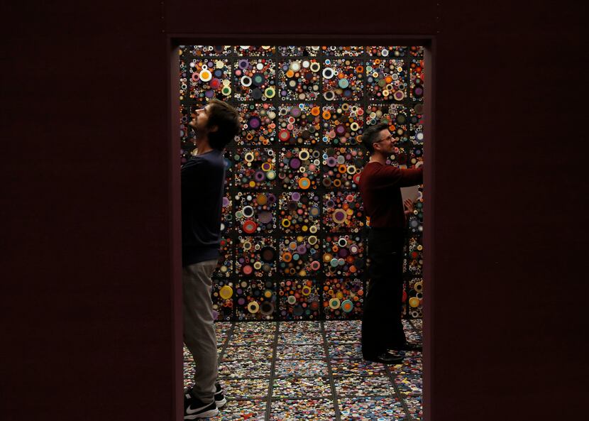 The artists William Ladd (left) and Steven Ladd (right) stand inside their work "Scroll...