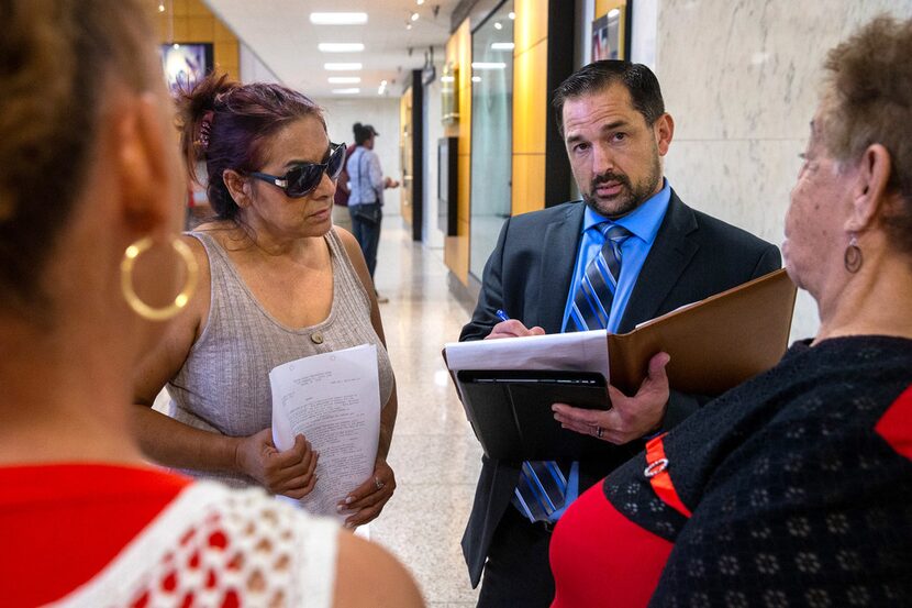 Immigration lawyer Dan Gividen spoke with Maria Munoz (left) and family members of his...