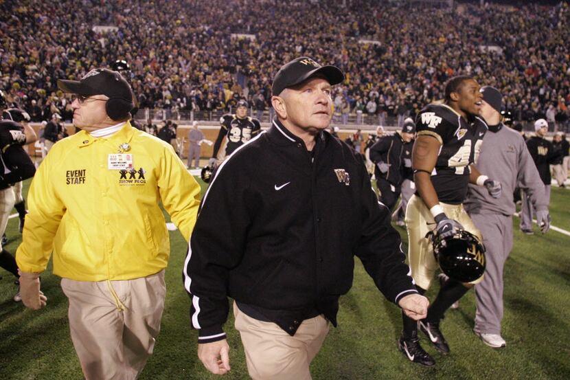 ** FILE ** Wake Forest head coach Jim Grobe walks off the field after their 21-14 win over...