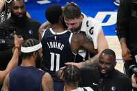 Dallas Mavericks guard Luka Doncic hugs guard Kyrie Irving after the Mavericks 108-105...