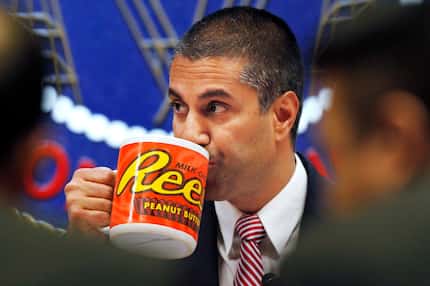 Federal Communications Commission Chairman Ajit Pai drinks from a mug during a  meeting...
