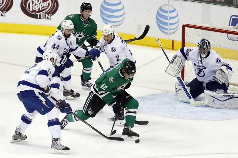 Dallas Stars right wing Alex Chiasson (12) attempts to get a shot off as he is surrounded by...