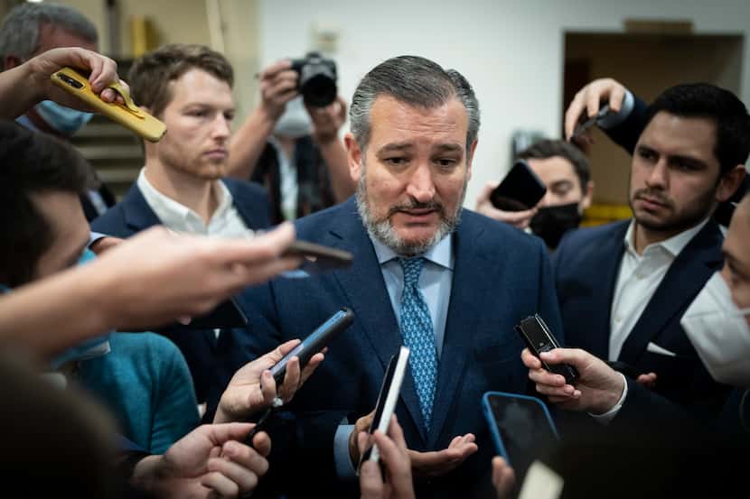 Sen. Ted Cruz talks with reporters on his way to a vote at the Senate on Dec. 2, 2021, a day...
